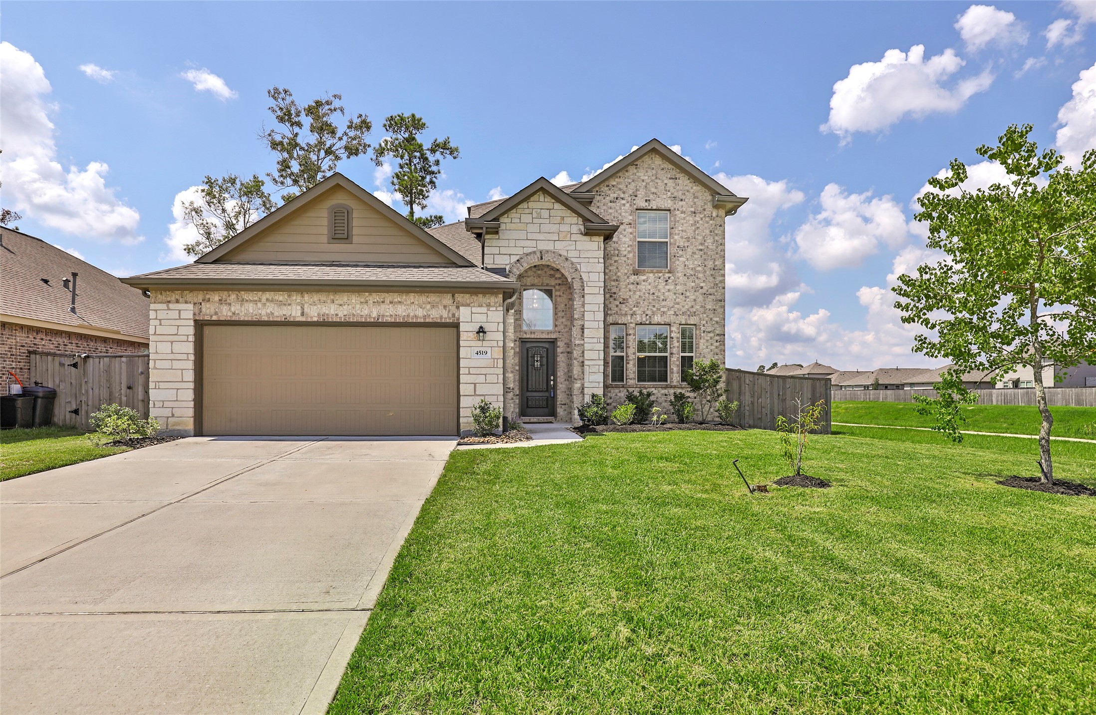 4519 Whitehaven Ridge Way Porter, TX 77365 - Photo 3 of 35 a front view of a house with a yard