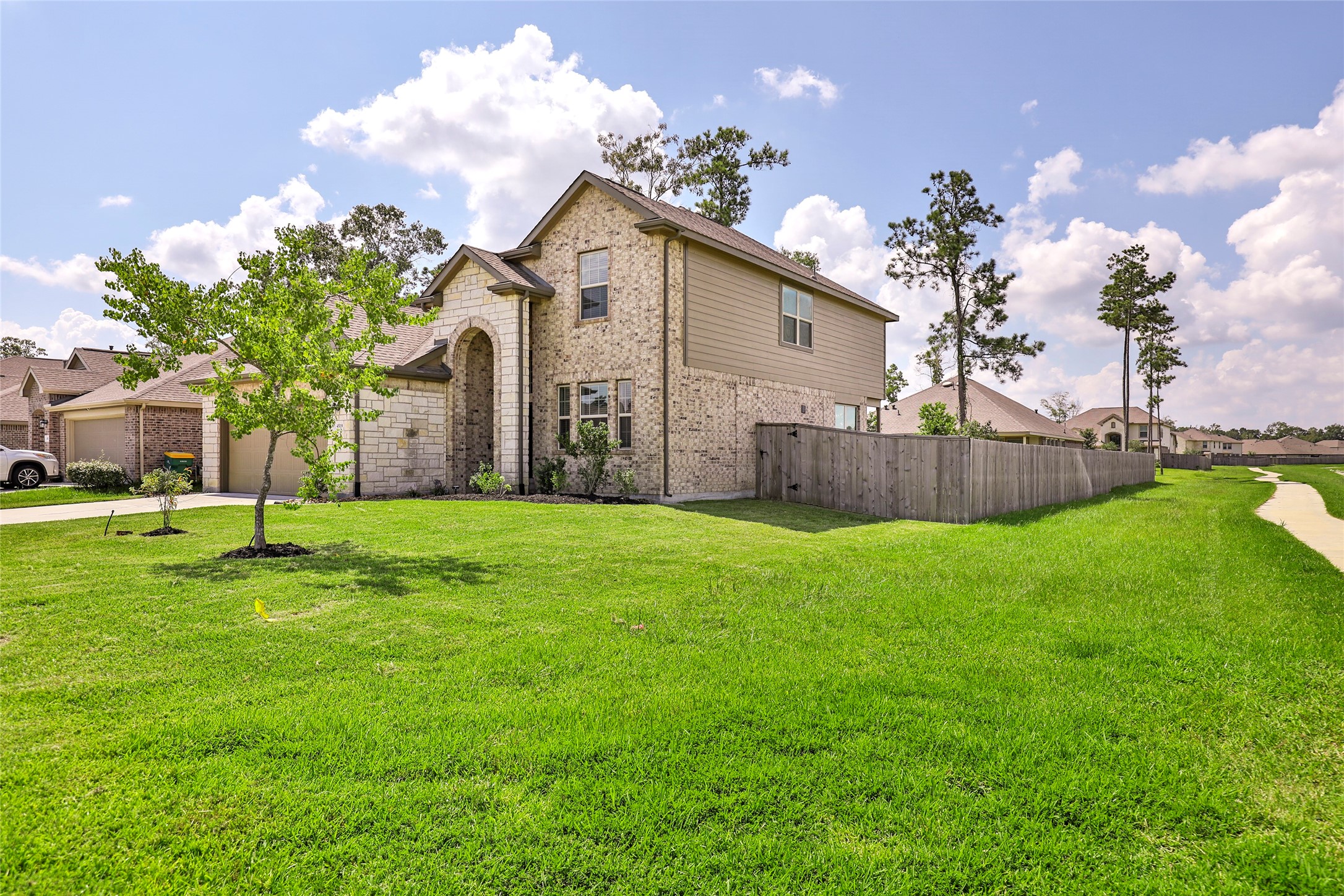 4519 Whitehaven Ridge Way Porter, TX 77365 - Photo 4 of 35 a view of a house with a yard and a garden