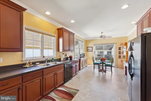 a kitchen with granite countertop a sink stove and refrigerator