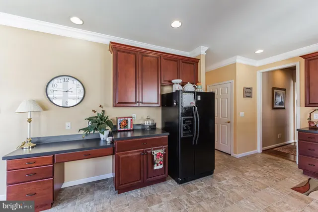 a kitchen with stainless steel appliances granite countertop a refrigerator and a stove top oven