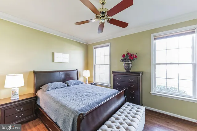 a bedroom with a bed dresser and a window