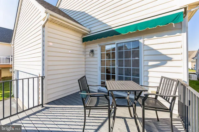 a view of a chairs and table in the balcony