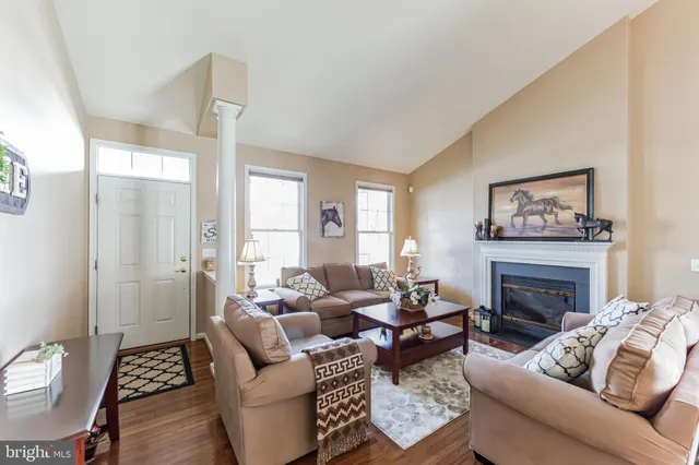 a living room with furniture a fireplace and a table