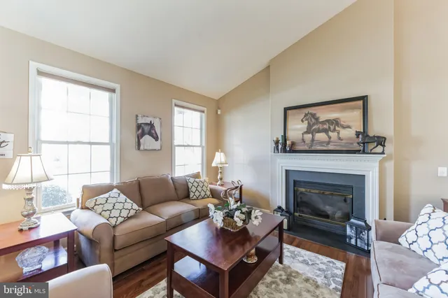 a living room with furniture a fireplace and window