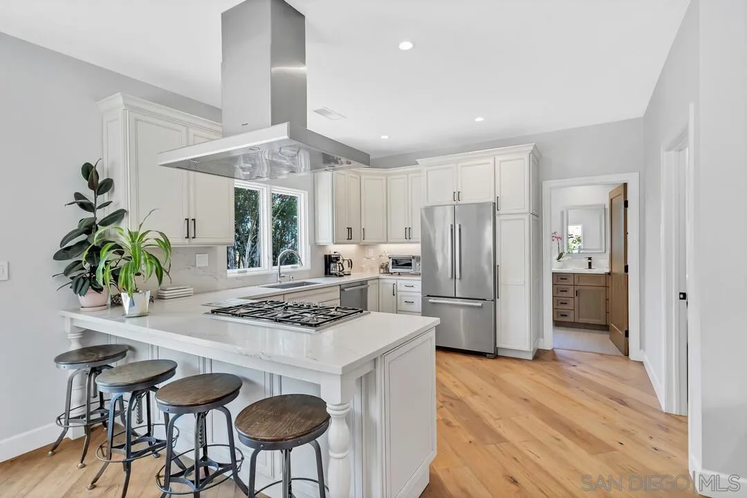 1356 Real Way Lane Alpine, CA 91901 - Photo 11 of 58 a kitchen with stainless steel appliances granite countertop a stove refrigerator and a table