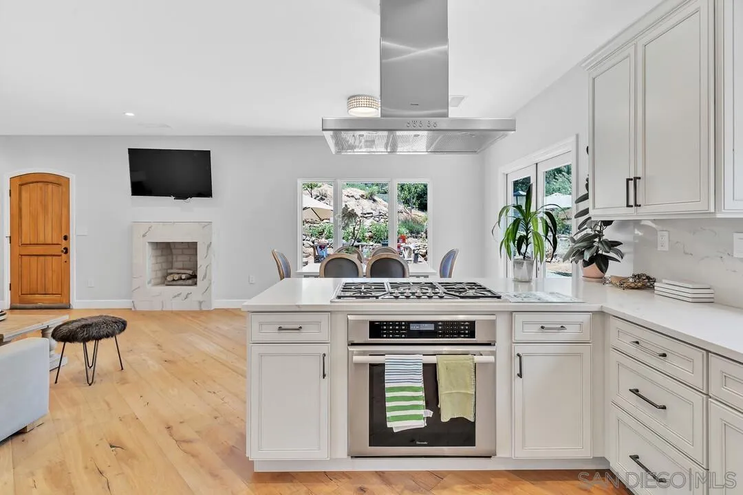 1356 Real Way Lane Alpine, CA 91901 - Photo 16 of 58 a kitchen with stainless steel appliances white cabinets and a stove top oven
