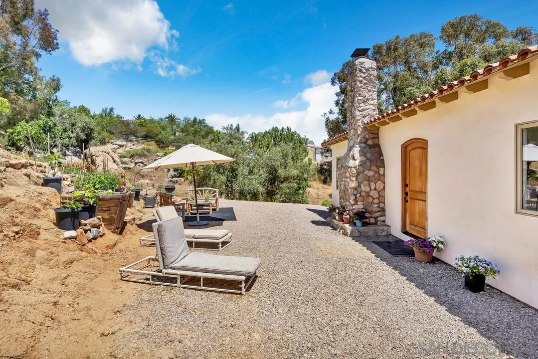 1356 Real Way Lane Alpine, CA 91901 - Photo 2 of 58 a table and chairs in front of a house