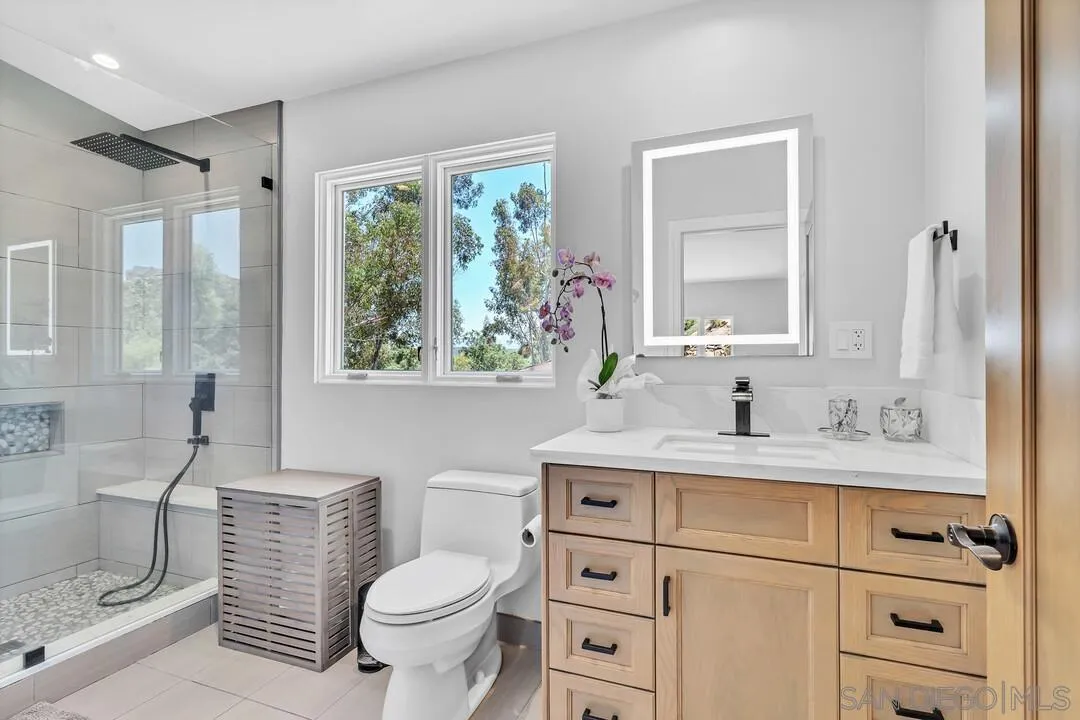 1356 Real Way Lane Alpine, CA 91901 - Photo 21 of 58 a bathroom with a granite countertop toilet sink and mirror