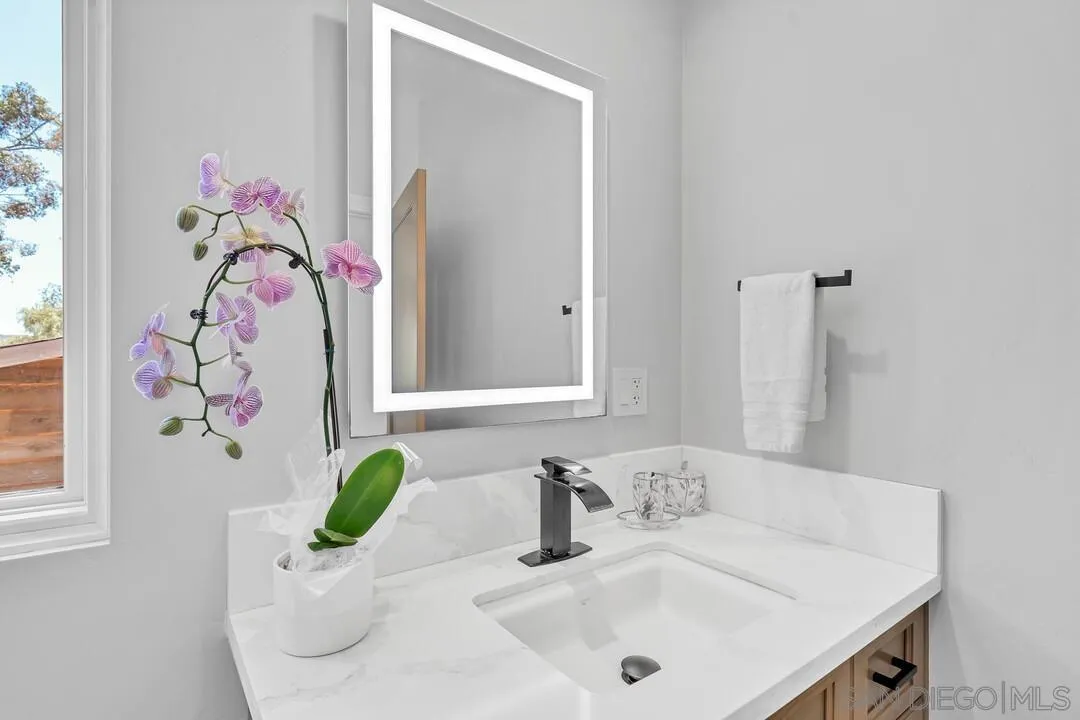1356 Real Way Lane Alpine, CA 91901 - Photo 25 of 58 a bathroom with a sink a mirror and vanity