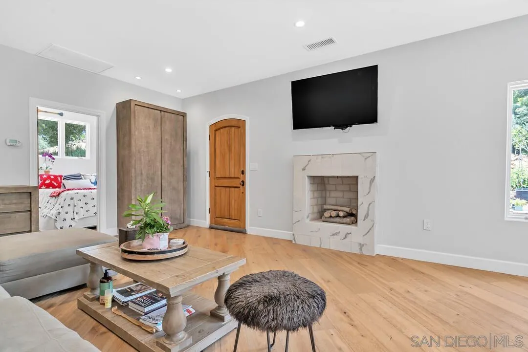 1356 Real Way Lane Alpine, CA 91901 - Photo 8 of 58 a living room with furniture a fireplace and a flat screen tv