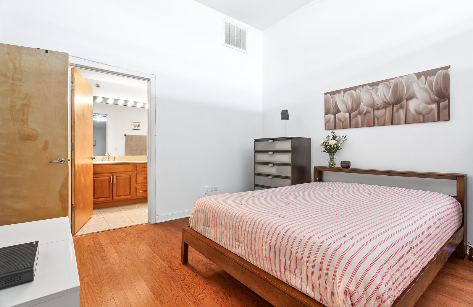 1224 West Van Buren Street, Unit 822 Chicago, IL 60607 - Photo 12 of 21 a bedroom with a bed and a painting on the wall