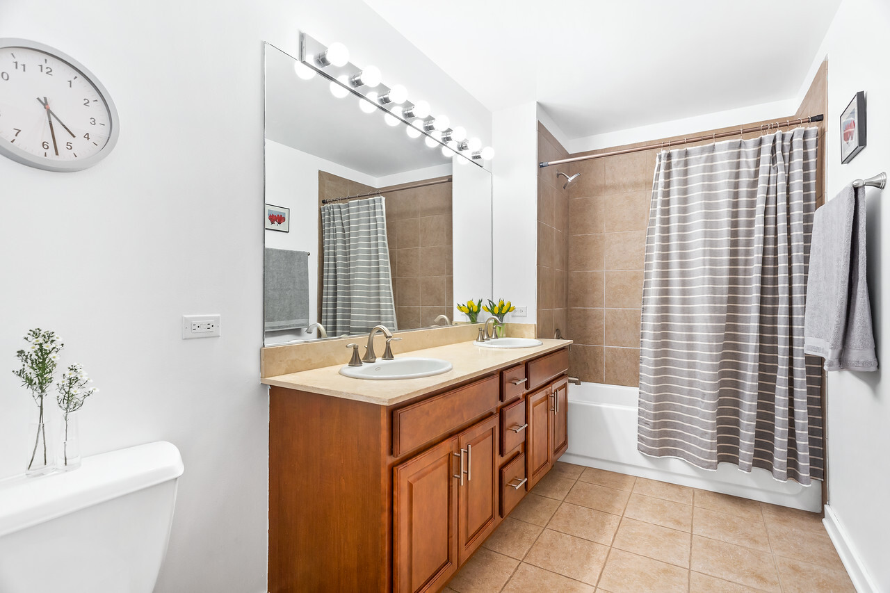 1224 West Van Buren Street, Unit 822 Chicago, IL 60607 - Photo 13 of 21 a bathroom with a sink a toilet and shower