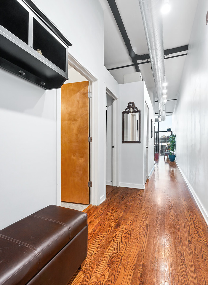 1224 West Van Buren Street, Unit 822 Chicago, IL 60607 - Photo 14 of 21 a living room with a couch and wooden floor