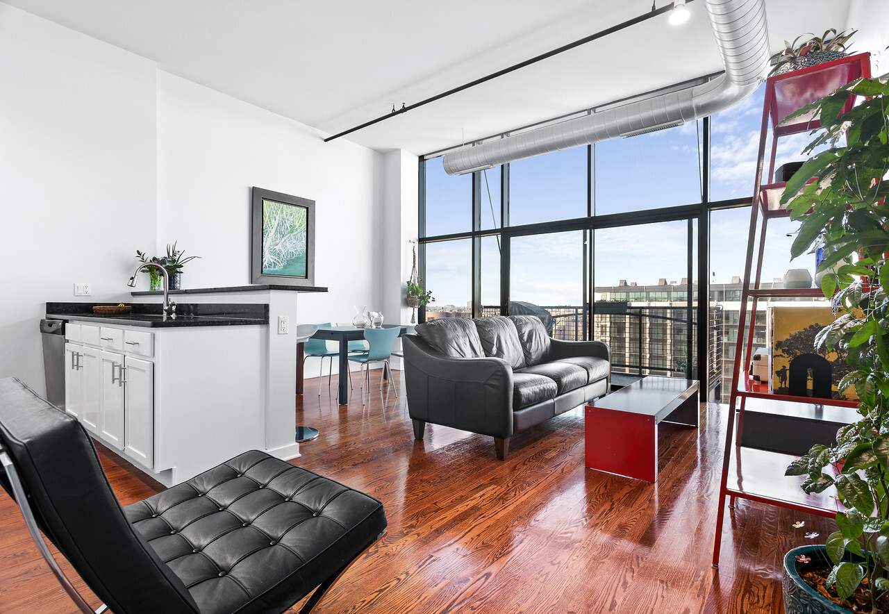 1224 West Van Buren Street, Unit 822 Chicago, IL 60607 - Photo 2 of 21 a living room with furniture and a large window