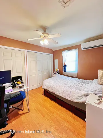 a bedroom with a large bed and a window