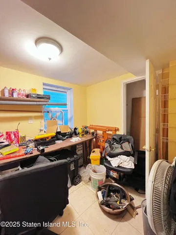 a room with furniture a rug and a potted plant