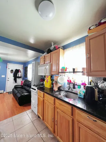 a kitchen with sink a window and cabinets