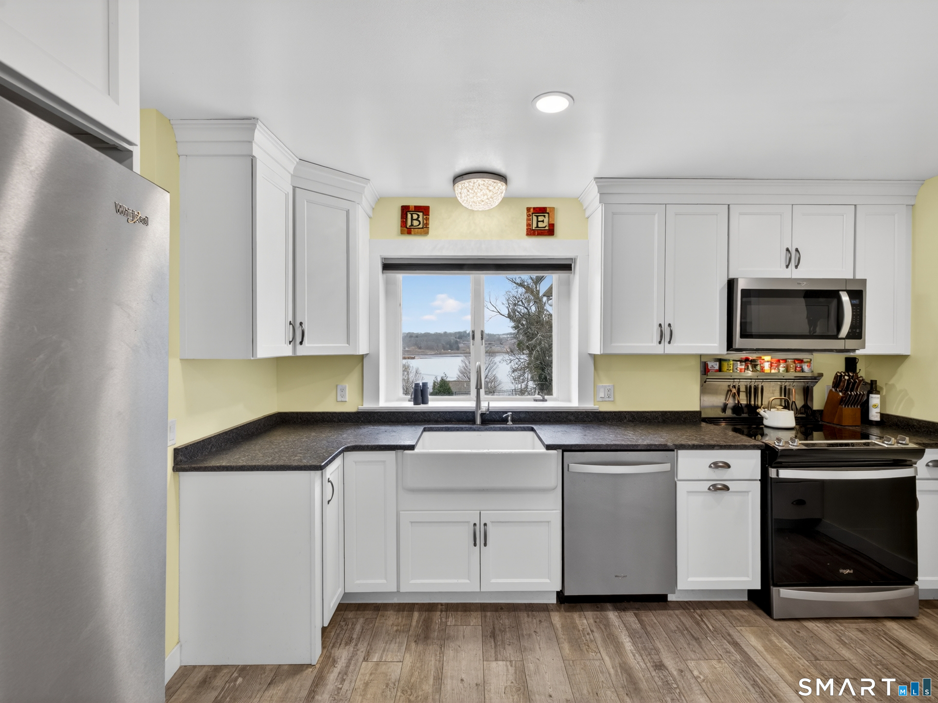 76 Starr Hill Road Groton, CT 06340 - Photo 10 of 40 a kitchen with granite countertop white cabinets and white appliances