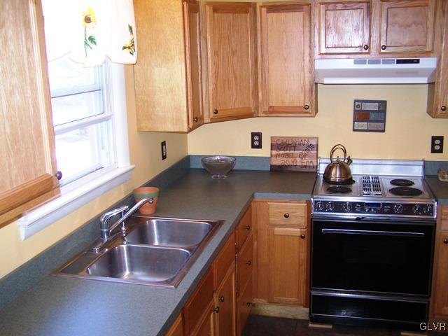496 Covered Bridge Road, Unit 1 Quakertown, PA 18951 - Photo 2 of 11 a kitchen with a sink stove and cabinets