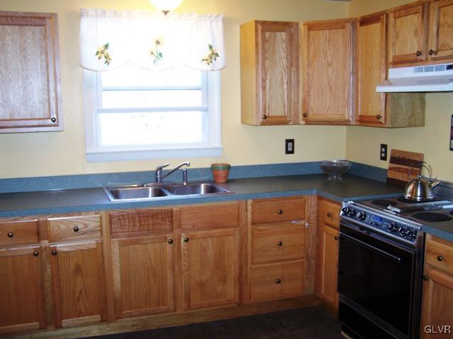 496 Covered Bridge Road, Unit 1 Quakertown, PA 18951 - Photo 3 of 11 a kitchen with cabinets appliances and a sink