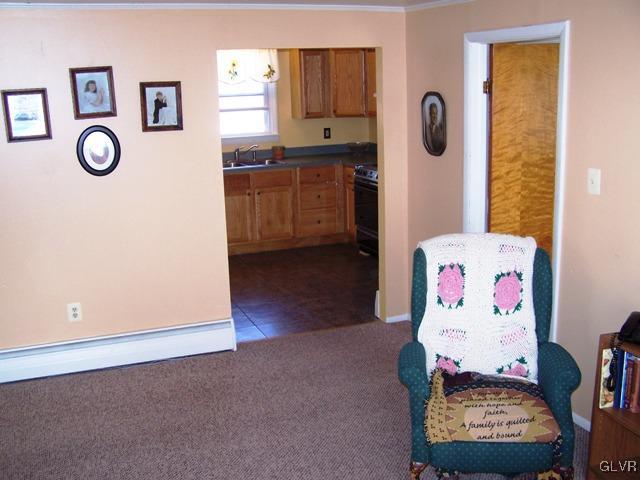 496 Covered Bridge Road, Unit 1 Quakertown, PA 18951 - Photo 7 of 11 a living room with granite countertop furniture and a flat screen tv