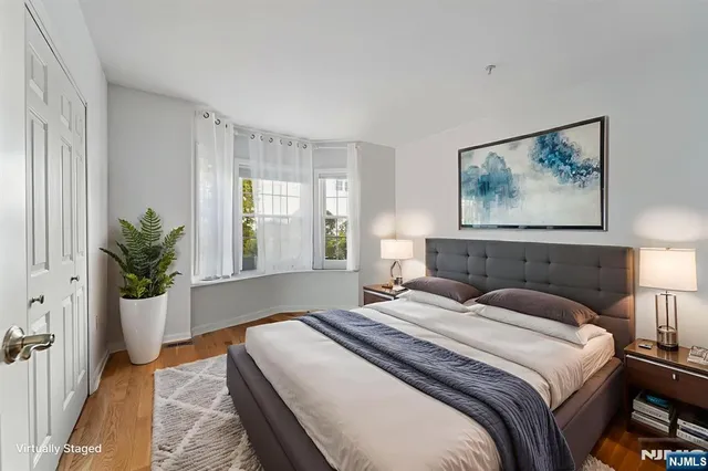 a bedroom with a large bed and a potted plant