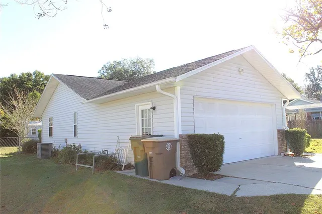 a view of a house with patio and a yard