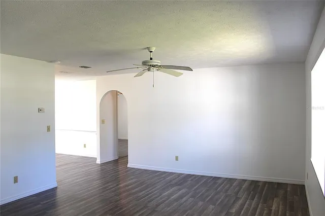 a view of a room with wooden floor and a window