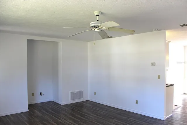 a view of a room with wooden floor