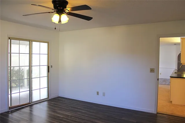 a view of a small space with wooden floor and a window