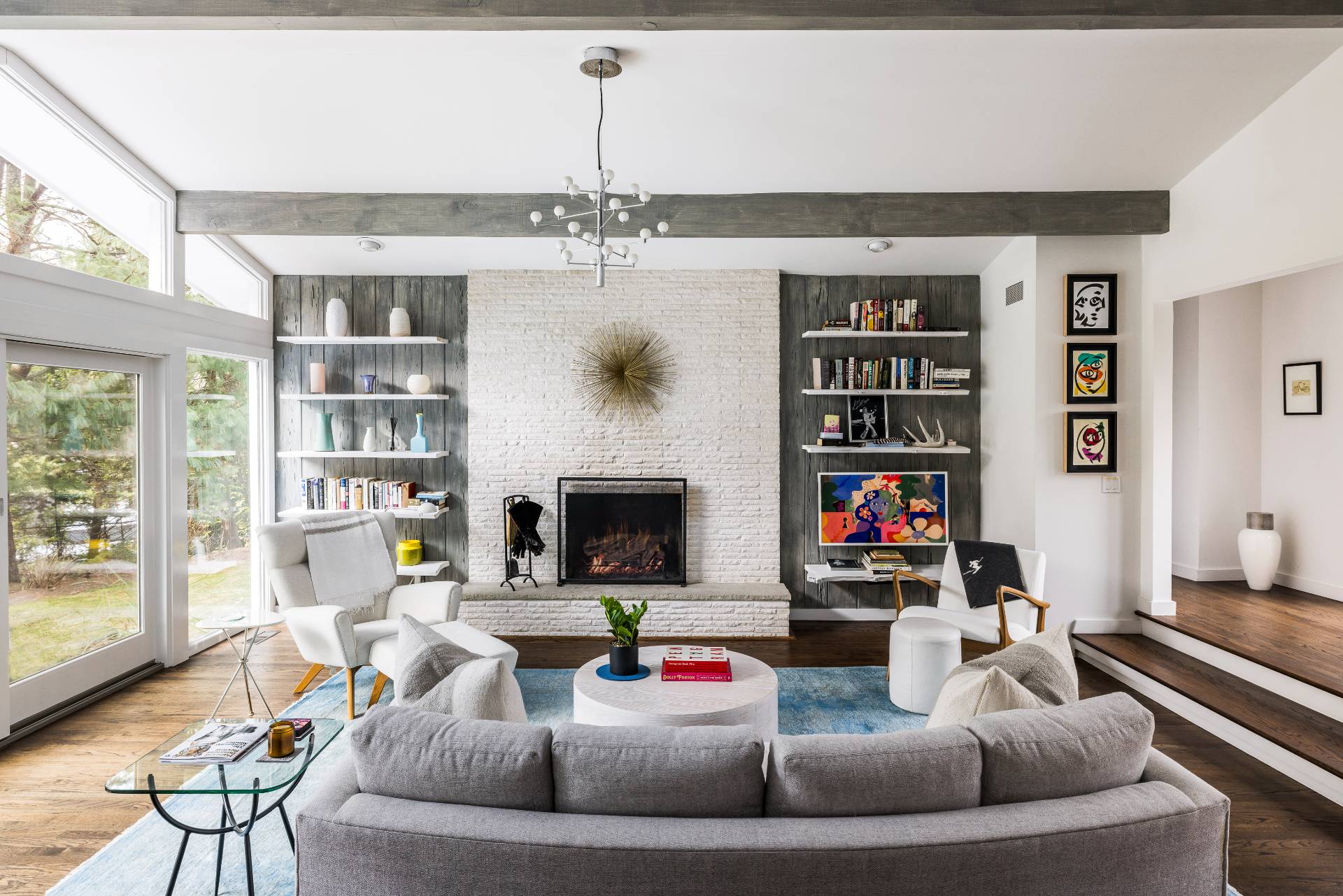 a living room with fireplace furniture and a book shelf