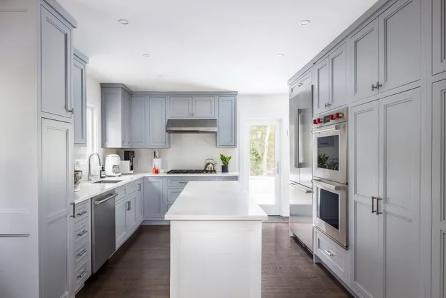 a kitchen with white cabinets and white appliances
