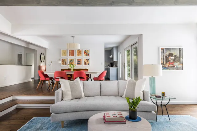 a living room with furniture and a potted plant