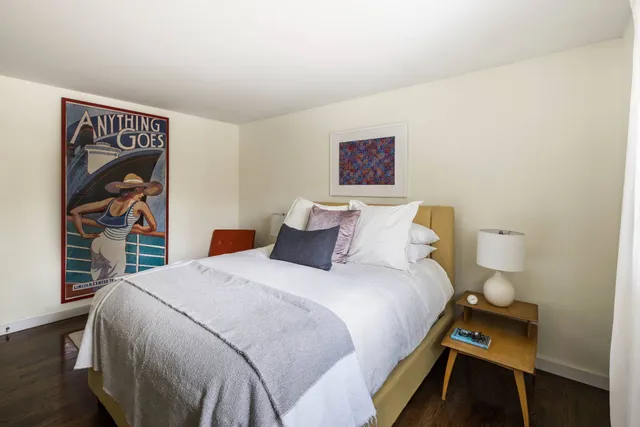 a bedroom with a bed and a book shelf