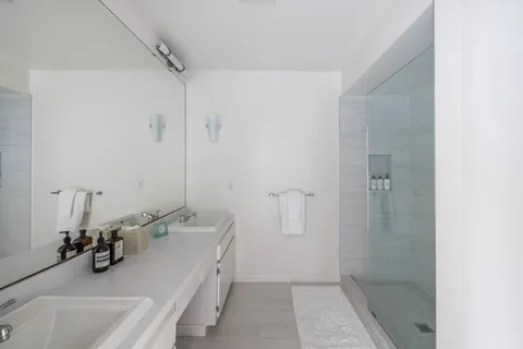 a bathroom with a sink a tub and a mirror