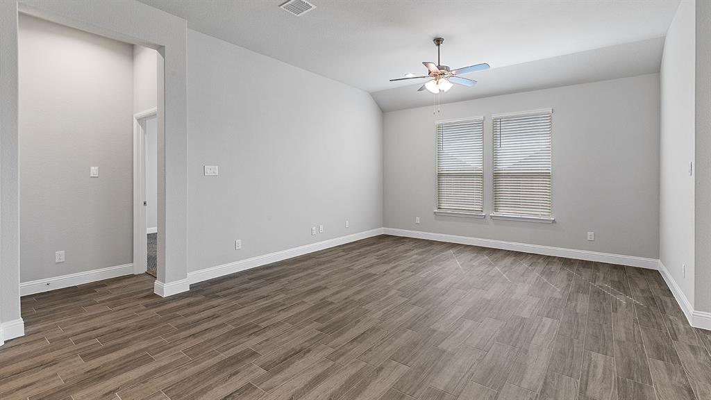11312 Treehouse Trail Justin, TX 76247 - Photo 10 of 31 wooden floor in an empty room with a window
