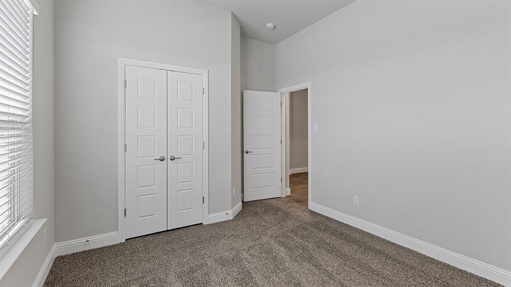 11312 Treehouse Trail Justin, TX 76247 - Photo 18 of 31 an empty room with windows