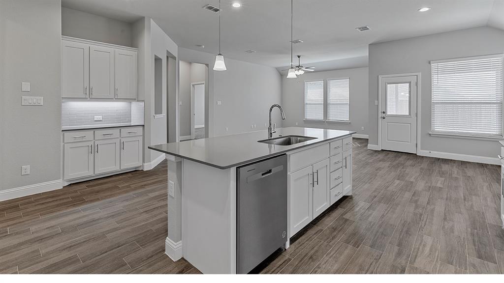 11312 Treehouse Trail Justin, TX 76247 - Photo 3 of 31 a kitchen that has a lot of cabinets in it and wooden floor