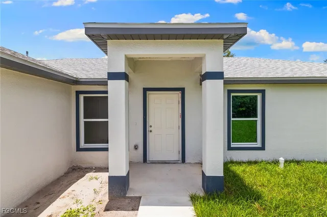 a front view of a house with a small yard