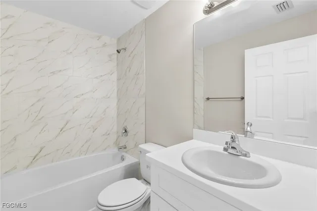 a bathroom with a toilet a sink and a bathtub