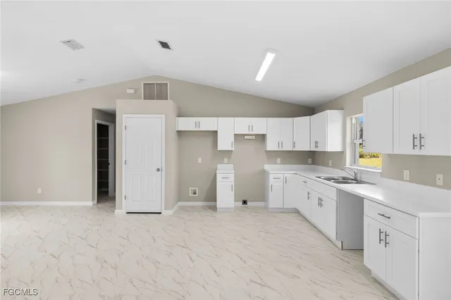 a large kitchen with cabinets and stainless steel appliances