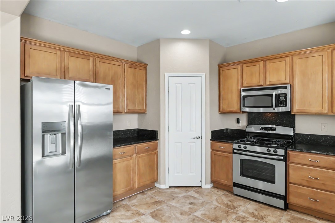 2356 Rue Bienville Way Henderson, NV 89044 - Photo 8 of 20 This functional kitchen provides a practical and efficient space for culinary endeavors.