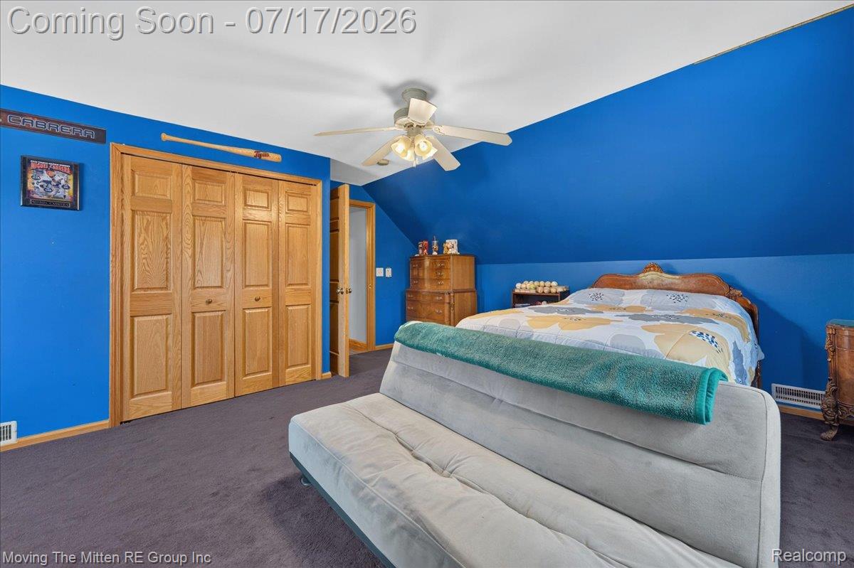 40162 Alden Road Belleville, MI 48111 - Photo 37 of 67 Bedroom featuring a ceiling fan, light-toned wood bi-fold closet doors, wall-to-wall carpeting, and sloped ceilings