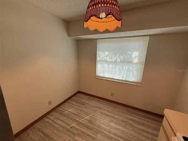 a room with a window and a chandelier