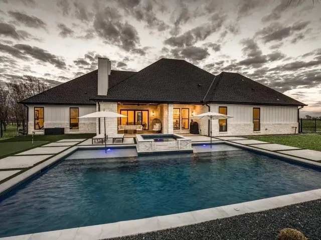 a view of a town with barn in the background