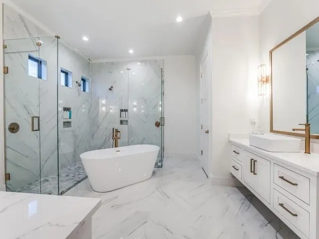 a spacious bathroom with a tub sink mirror and shower