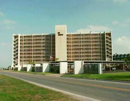 a front view of a building with a yard