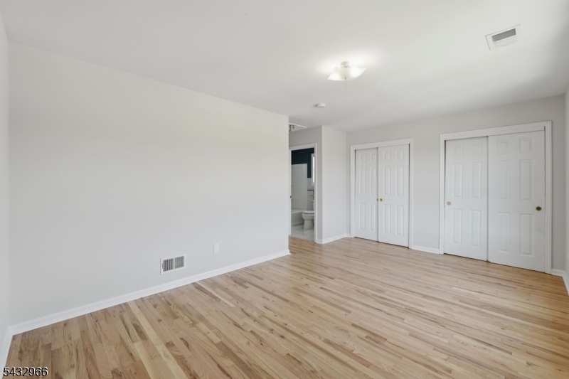 130 3rd Street, Unit 2 Passaic, NJ 07055 - Photo 4 of 12 a view of empty room with wooden floor