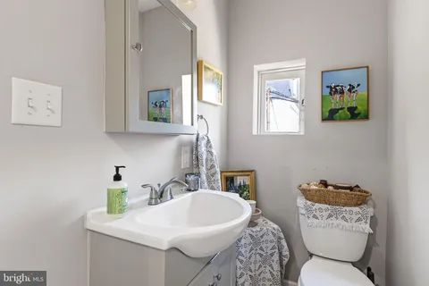a bathroom with a sink mirror and toilet