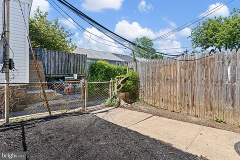 a view of a backyard with wooden fence